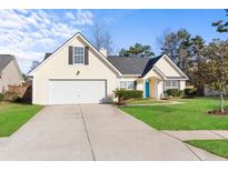 Charming single Gathering home with a well maintained lawn, driveway and a bright blue front door at 322 Equinox Cir, Ladson, SC 29456
