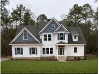 Charming two-story home boasts a well-manicured lawn, white siding, blue accents, and inviting front porch at Ln, Walterboro, SC 29488