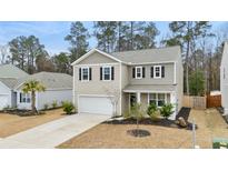 Charming two-story home with a well-manicured lawn and a welcoming entrance at 103 Cardinal Flower Ct, Moncks Corner, SC 29461