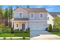 Charming two-story home features a manicured lawn and a two-car garage at 116 Threaded Fern St, Summerville, SC 29485