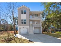 Charming two-story home featuring double balconies, dual garages and an inviting exterior at 1439 Periwinkle Dr, Mount Pleasant, SC 29466