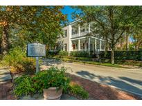 Charming two-story home with double porches, nestled among trees on Shipyard Road at 186 N Shelmore Blvd, Mount Pleasant, SC 29464