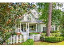 Charming two-story home with light green siding, covered porch, and well-manicured landscaping at 2076 Rookery Ln, Charleston, SC 29414