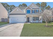 Charming two-story home with a well-manicured lawn and a two-car garage in a neighborhood setting at 218 Alpine Rd, Summerville, SC 29485