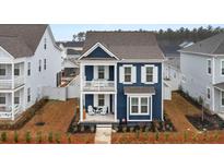 Attractive two-story blue home featuring double porches and neat landscaping at 219 Symphony Ave, Summerville, SC 29486