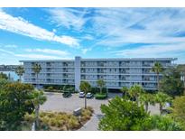 Beautiful view of the Twin Rivers Condominiums with well maintained landscaping and plenty of parking space at 2395 Folly Road # 4H, Folly Beach, SC 29439