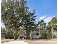 Beautiful two-story home with a large yard, mature trees, and inviting balconies at 2784 Hidden Oak Dr, Seabrook Island, SC 29455