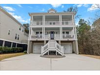 Stunning three-story home with double balconies, staircase, and a two-car garage at 530 Amalie Farms Dr, Charleston, SC 29492