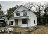 Charming two-story home featuring white siding, a welcoming front porch, and classic architectural details at 5806 Beverly Dr, Hanahan, SC 29410