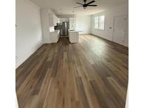 Spacious living room featuring modern lighting, wood-style flooring, and a bright, airy open floor plan at 1137 Moss Grove Dr Dr, Moncks Corner, SC 29461