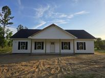 Charming single-story home boasts a classic design with symmetrical windows and a welcoming front porch at 149 Rose Ave, Walterboro, SC 29488