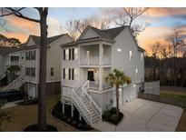 Charming two-story coastal home with double porches and manicured landscaping, great curb appeal at 1918 Essex Farms Dr, Charleston, SC 29414