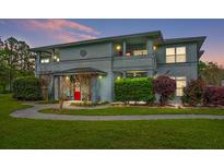 Charming two-story condo with a manicured front lawn and vibrant landscaping at 3205 Mariners Way, Moncks Corner, SC 29461