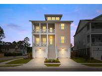 Two-story home showcasing a charming exterior with double balconies, complemented by a well-maintained front yard and garage at 325 Blowing Fresh Dr, Charleston, SC 29492