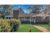Charming single-story brick home with a well-manicured lawn and inviting front porch at 409 Dowling Ave, Walterboro, SC 29488