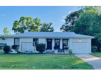 Charming single-story home featuring a welcoming front porch, well-maintained lawn, and an attached garage at 4437 Logwood Dr, Ladson, SC 29456