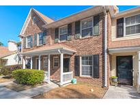 Charming brick townhouse with a covered front porch and dark shutters at 509 Reserve Way, Summerville, SC 29485