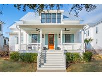 Charming two-story home featuring a welcoming front porch, stylish shutters, and a well-manicured lawn at 5742 Kiawah River Dr, Johns Island, SC 29455