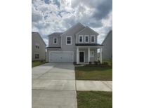 Charming two-story home with gray siding, a two-car garage, and a well-manicured front lawn at 598 Red Monarch Way, Moncks Corner, SC 29461