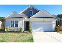 Charming one-story home featuring a two-car garage, tidy landscaping, and a welcoming front entrance at 625 Woolum Dr, Moncks Corner, SC 29461