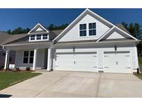 New two-story home featuring white siding, a two-car garage and concrete driveway at 727 Maynard Ln, Summerville, SC 29486