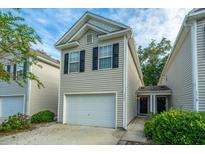 Charming two-story home featuring a one-car garage and well-maintained landscaping at 1320 Garland St, North Charleston, SC 29420