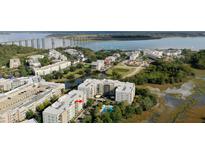 Scenic aerial view of condo community with water views, a swimming pool, and easy access to the bridge at 135 Pier View St # 304, Charleston, SC 29492