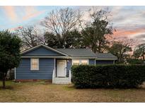 Charming single-story home with blue siding, complemented by a well-manicured front yard and inviting entrance at 1426 Bexley St, North Charleston, SC 29405