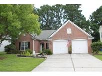 Charming single-story brick home with an attached two-car garage and well-manicured lawn at 1481 Clarendon Way, Mount Pleasant, SC 29466