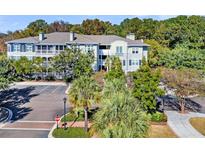 Beautiful building featuring screened-in porches and manicured landscaping at 1623 Telfair Way, Charleston, SC 29412