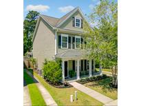 Charming two-story home with a welcoming front porch and well-manicured lawn in a desirable neighborhood at 1747 Towne St, Johns Island, SC 29455