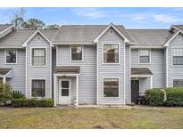 Exterior view of townhomes featuring light gray siding and well-maintained landscaping at 1750 Deer Path Dr, Mount Pleasant, SC 29464
