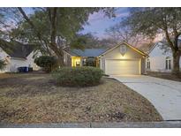 Charming one-story home with a two-car garage, landscaped yard, and inviting curb appeal at 1942 Oak Tree Ln, Mount Pleasant, SC 29464