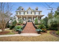 Charming two-story home with a welcoming front porch and manicured landscaping at 2217 Beckenham Dr, Mount Pleasant, SC 29466