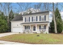 Charming two-story home with a welcoming front porch and well-maintained landscaping at 2438 Albacore Ave, North Charleston, SC 29406