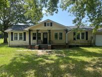 Quaint single story home with a covered front porch and a charming, symmetrical facade at 3657 Santee River Rd, Saint Stephen, SC 29479