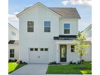 Charming two-story home featuring a one car garage, craftsman details, and a neatly manicured lawn at 420 Queen View Ln, Charleston, SC 29414