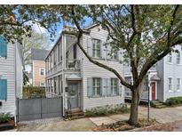 Charming two-story home with a welcoming front porch and beautiful light gray exterior paint at 54 Warren St, Charleston, SC 29403