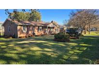 Charming brick home featuring a well-manicured lawn and beautiful landscaping at 904 Randall Dr, Mount Pleasant, SC 29464