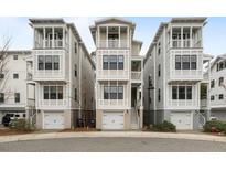 Three-story townhomes featuring private garages, multiple balconies and neutral color scheme at 972 Key Colony Ct, Mount Pleasant, SC 29464