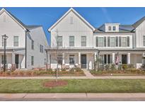 Charming two-story townhome with a manicured lawn and welcoming front porch at 131 Summer Tanager Dr, Ravenel, SC 29470