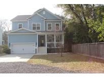 Charming two-story home with a welcoming front porch and a well-manicured lawn at 1601 Secessionville Rd, Charleston, SC 29412