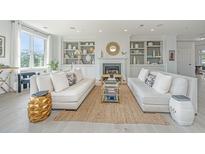 Bright living room featuring white sofas, built-in shelves, and a cozy fireplace, perfect for entertaining at 245 Seven Farms Dr # 330, Charleston, SC 29492