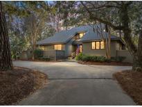 Charming single-Gathering home featuring a private driveway and an inviting, landscaped front yard at 385 Green Winged Teal Rd, Kiawah Island, SC 29455