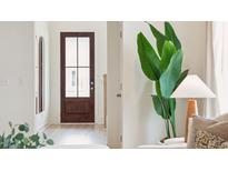 Inviting entryway with a stylish front door, light hardwood floors, and a decorative plant bringing the outdoors inside at 418 Grove End Rd, Moncks Corner, SC 29461