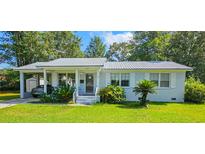 Charming single-story home with a metal roof, covered carport, and beautifully landscaped front yard at 422 Academy Rd, Walterboro, SC 29488