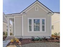 Charming home exterior with neutral siding, white trim, and well-maintained landscaping at 810 Gentle Breeze Dr, Summerville, SC 29486