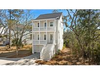 Charming two-story home with double balconies, well-manicured landscaping, and private drive at 836 Forrest Dr, Charleston, SC 29492