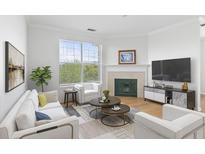 Bright living room with a fireplace, large window, and modern furnishings at 130 River Landing Dr # 7309, Charleston, SC 29492