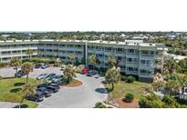 Condominium complex featuring ample parking and mature landscaping, offering convenient coastal living at 1300 Ocean Blvd # 102 A, Isle of Palms, SC 29451